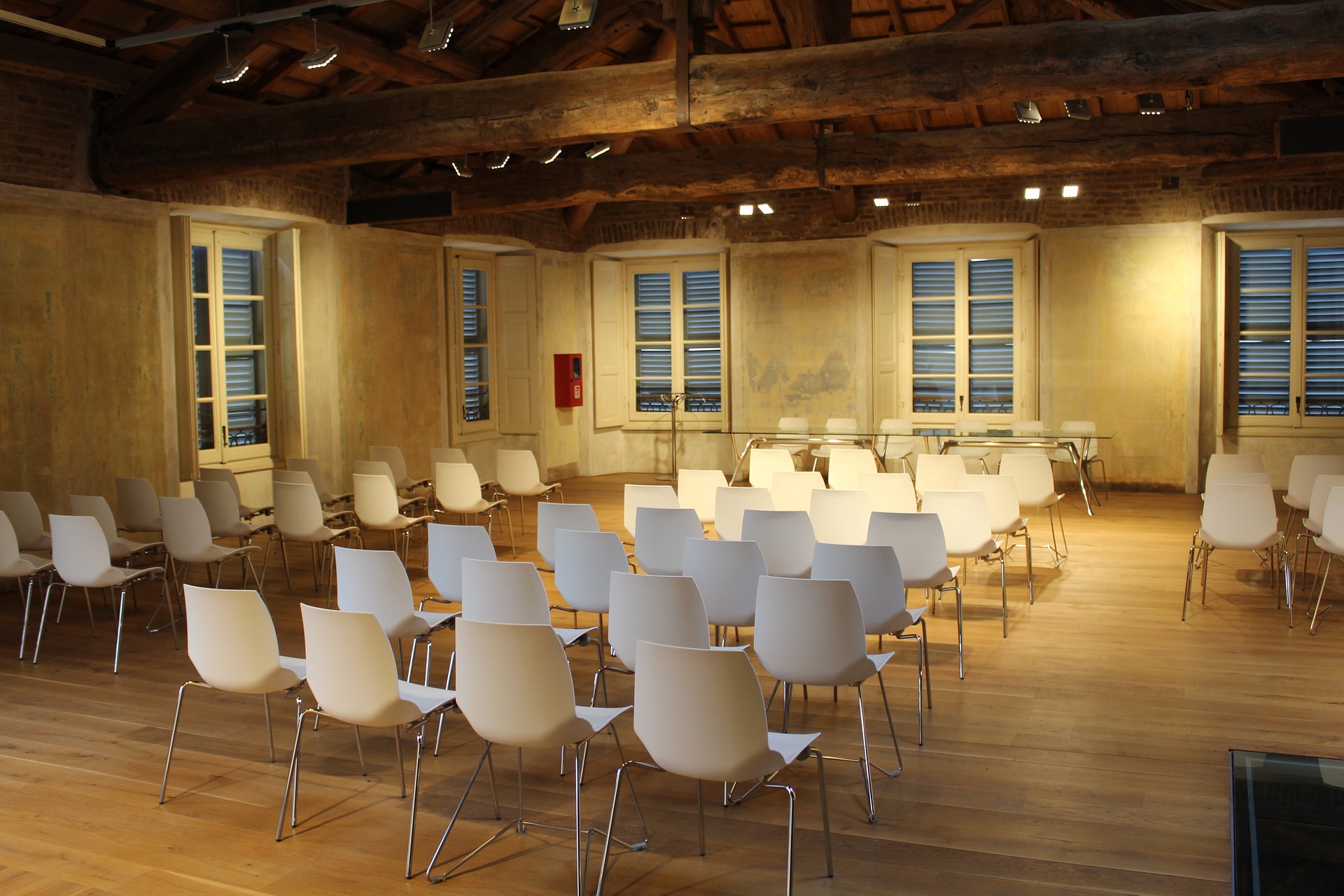People in a meeting room with a large screen displaying a game